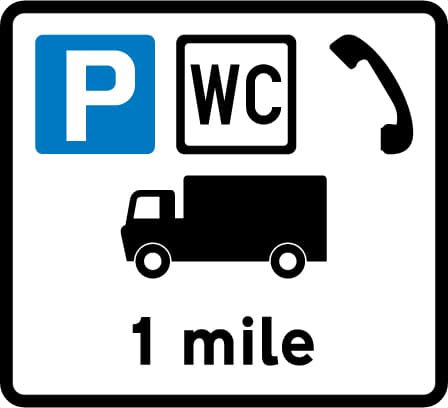 Distance to a commercial vehicles parking place ahead with public toilets and telephones