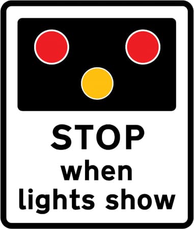 Warning of light signals at a level crossing without a gate or barrier ahead