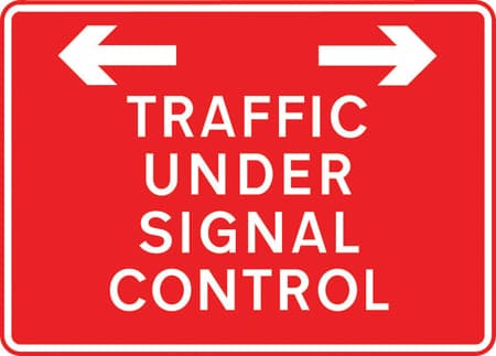 Traffic on road ahead is being controlled by portable light signals